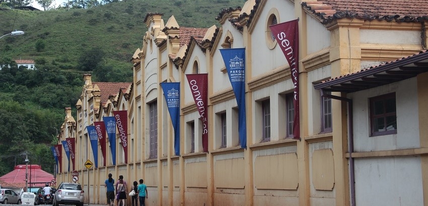 Imagem do prédio histórico do Centro de Convenções com jovens passando pela calçada